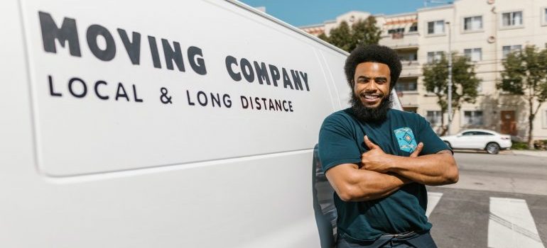 movers standing next to a moving van