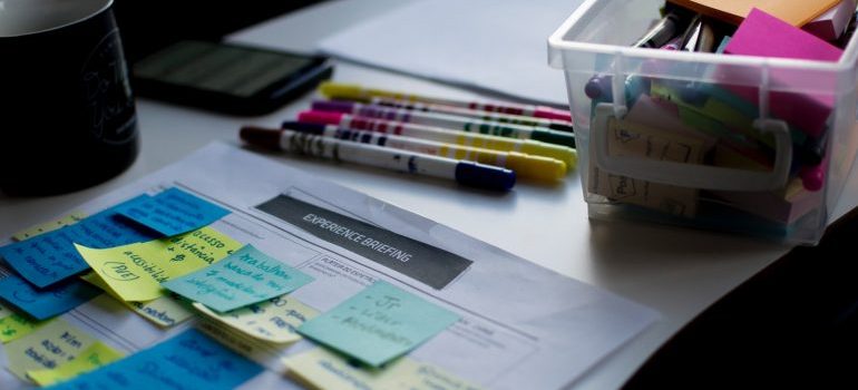 Plans, notes, and markers on the table.