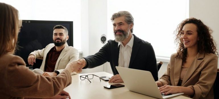 people shaking hands in a meeting