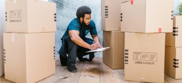 homestead fl movers inspecting packed boxes