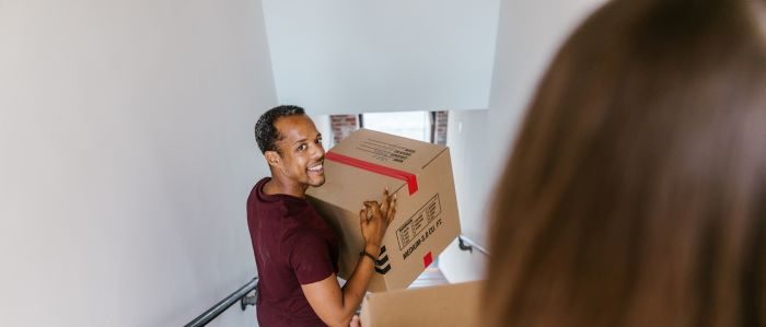 Couple in the middle of a move, on a staircase.