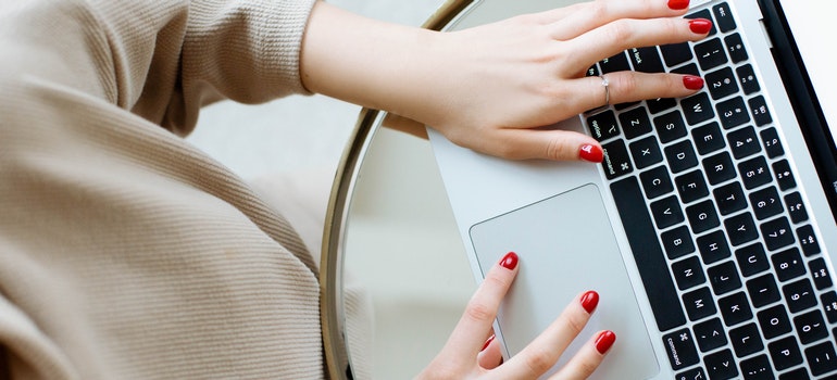 A woman typing on a laptop