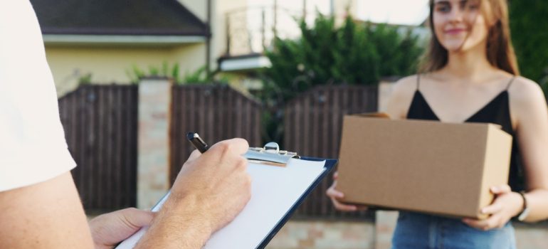 A woman with a cardboard box.