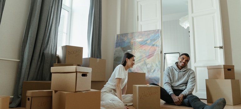 A couple sitting on the floor