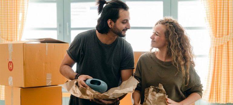 two people packing for a move