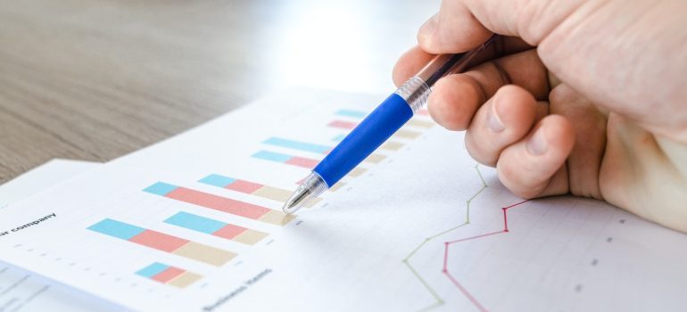 Hand showing statistic charts.