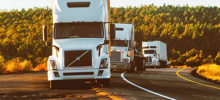 three trucks on the road