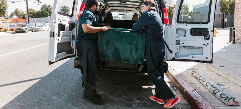 Movers carrying a sofa