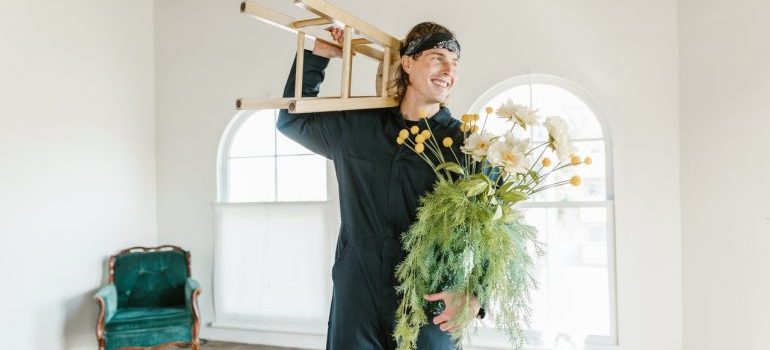 a man holding flowers while unloading the truck