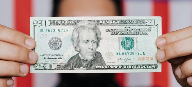 person holding a $20 bill