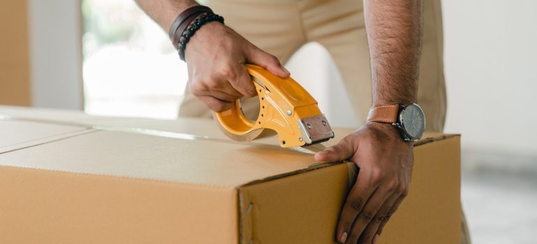 A man packing a moving box