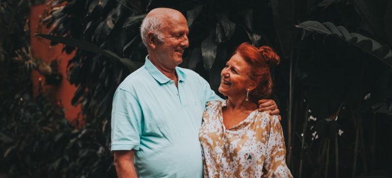 Elder couple hugging and laughing.