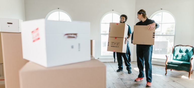 commercial movers carrying moving boxes
