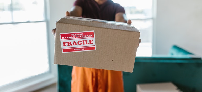 a guy holding labeled box