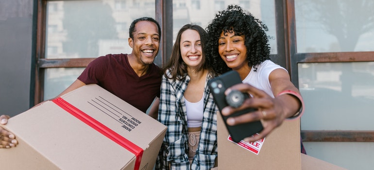 three people taking selfie