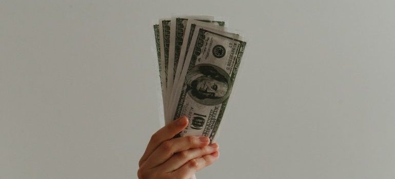 Person holding dollar bills