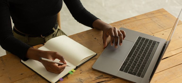 A person with a laptop taking notes - long distance movers Riverview FL