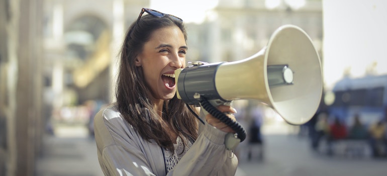 a happy woman using megaphone