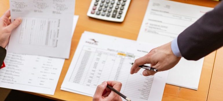 Two persons looking at the documents.