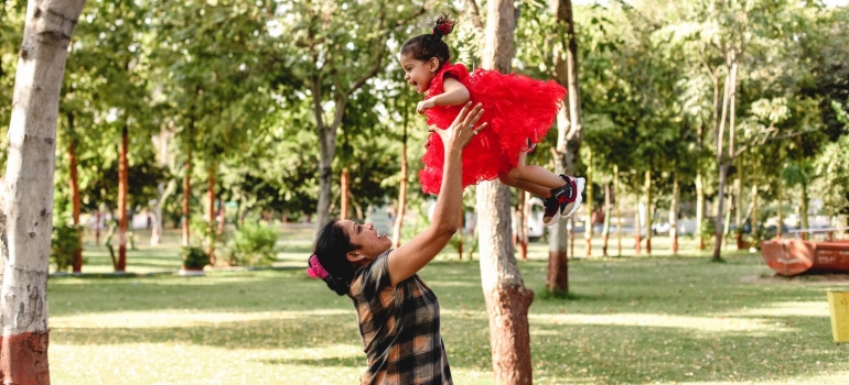 A woman and a child playing in the park