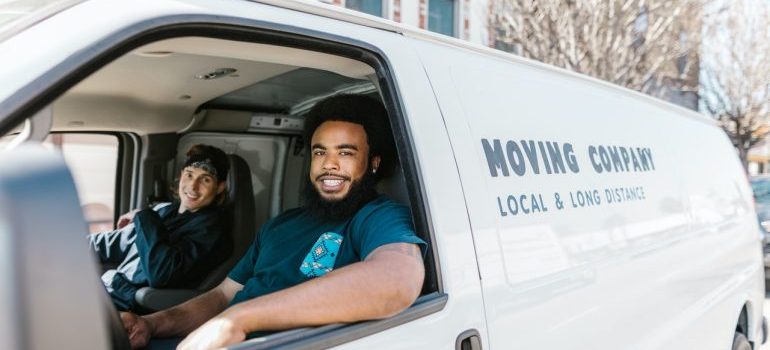 Two movers in a moving van.