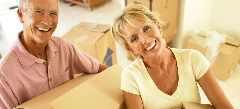 elderly couple with moving boxes