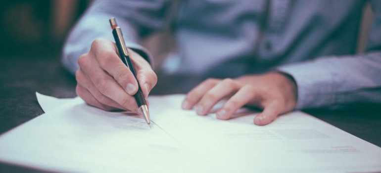 a man signing the papers