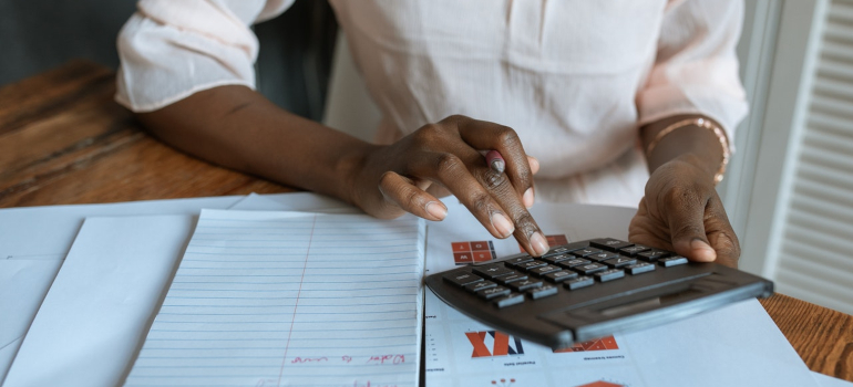 a woman sitting in his kitchen calculating expenses so he can organize a low cost move to Orlando