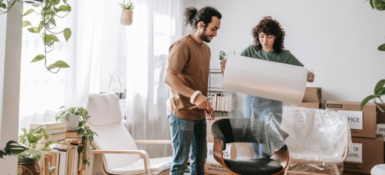 A couple preparing things for storage