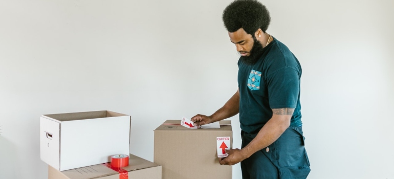 A professional mover packing boxes