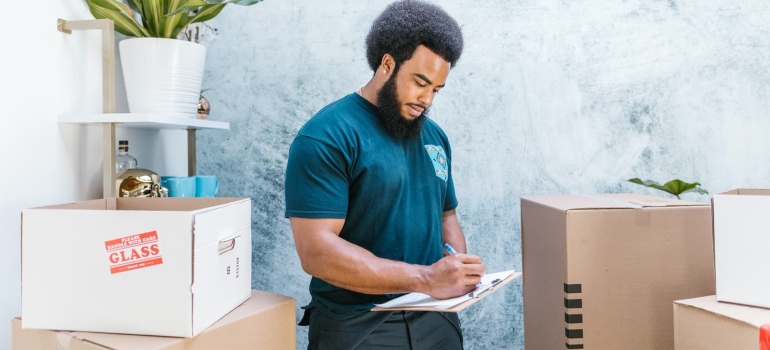 A professional mover checking the inventory list