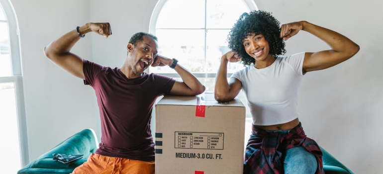 Happy couple next to a box