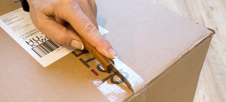 person unsealing a box