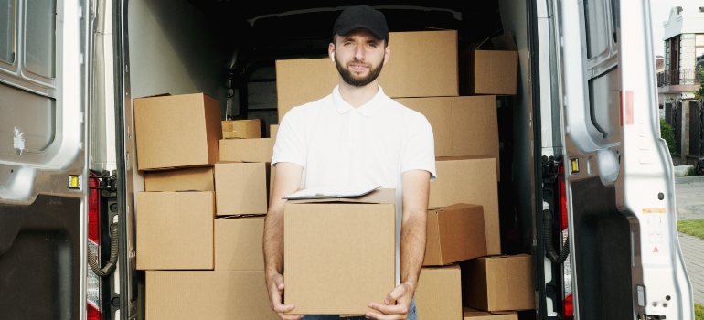 a man holding a moving box