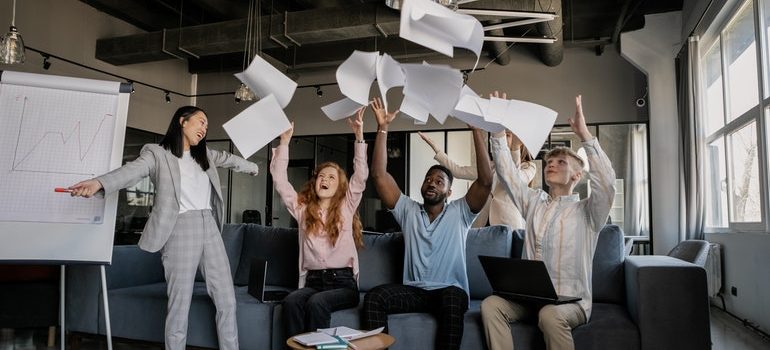 office workers celebrating moving to a new space