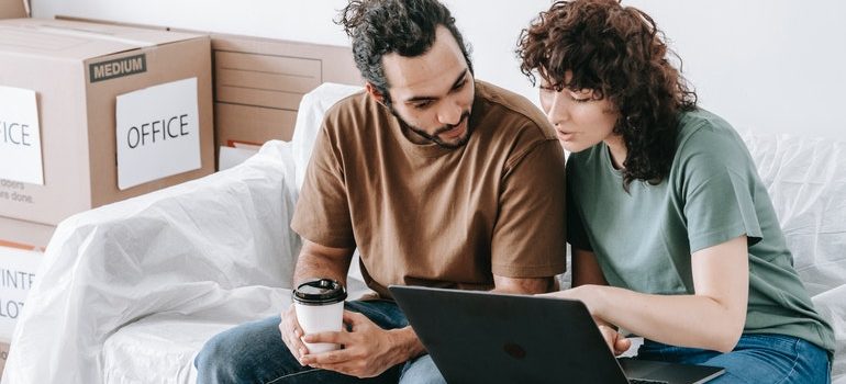 couple comparing movers on a laptop