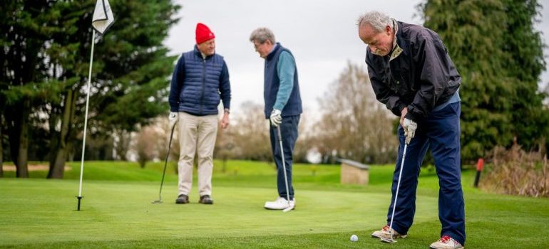 men playing golf and talking about fun things to do in Plantation