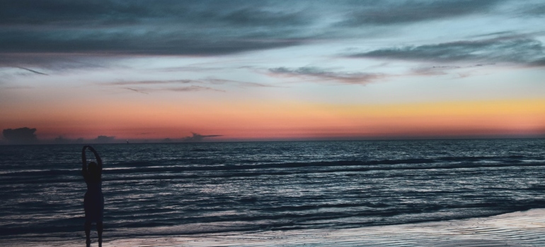 Person watching the sunset on the beach 