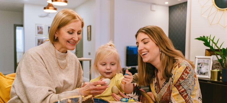 a grandmother, young mother and a baby celebrating