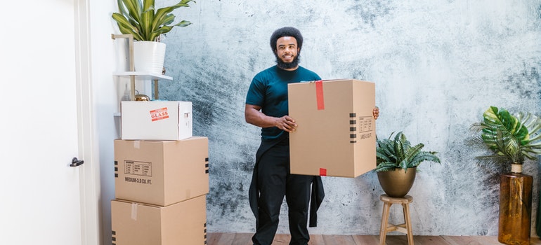 a man holding a carton box