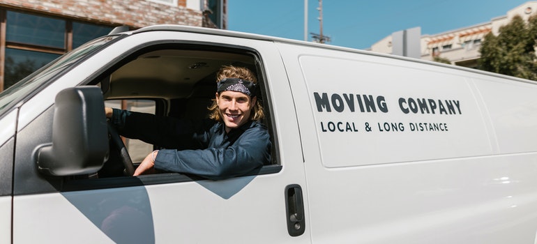 worker from long distance movers Weston FL sitting in a van