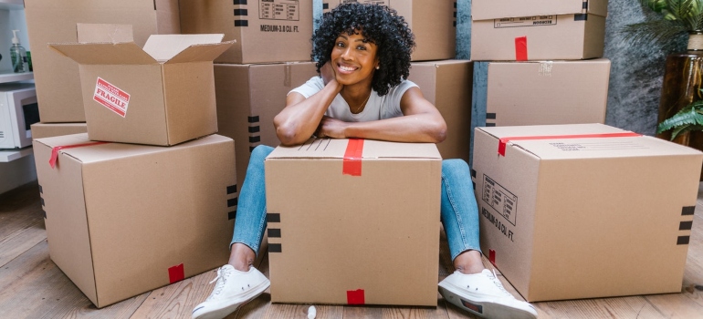 A happy woman surrounded by boxes