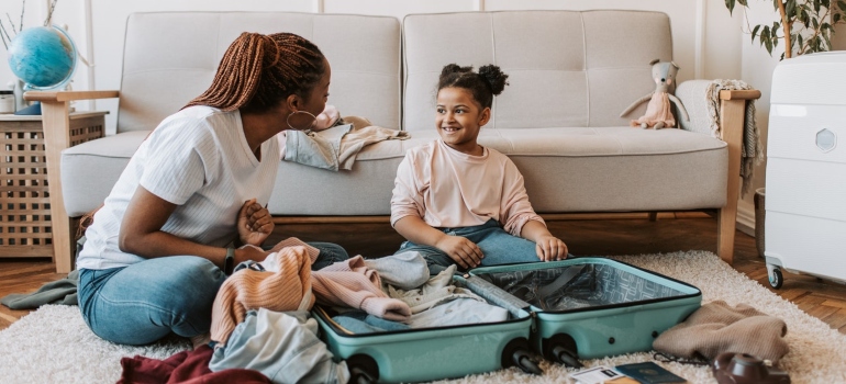 A mother and daughter packing for a moving over summer