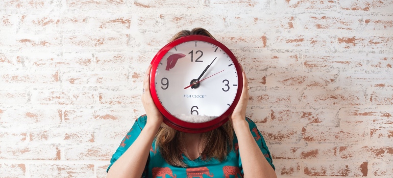 a woman holding a clock