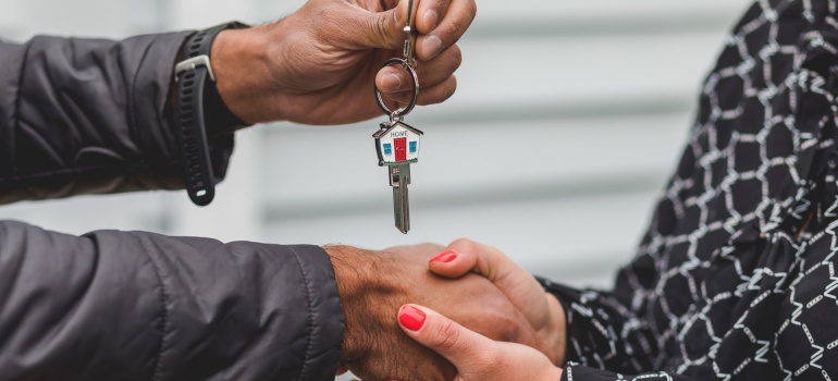 best movers Key West FL giving house keys to a woman