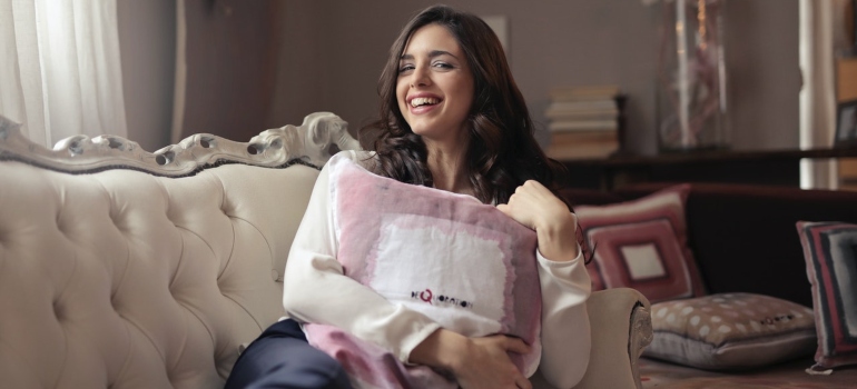 a woman smiling on a couch