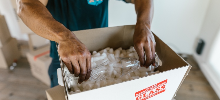 a man packing glassware 