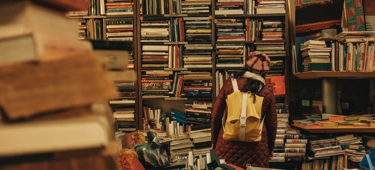 A boy in front of a home library