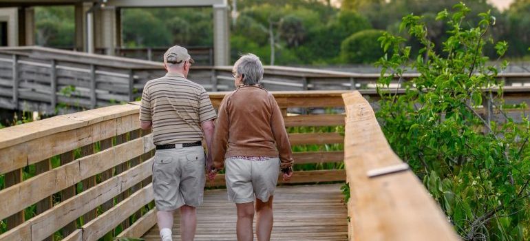two elderly people taking a walk and enjoying Delray Beach