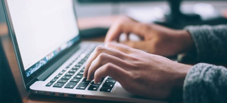 hands typing on a computer